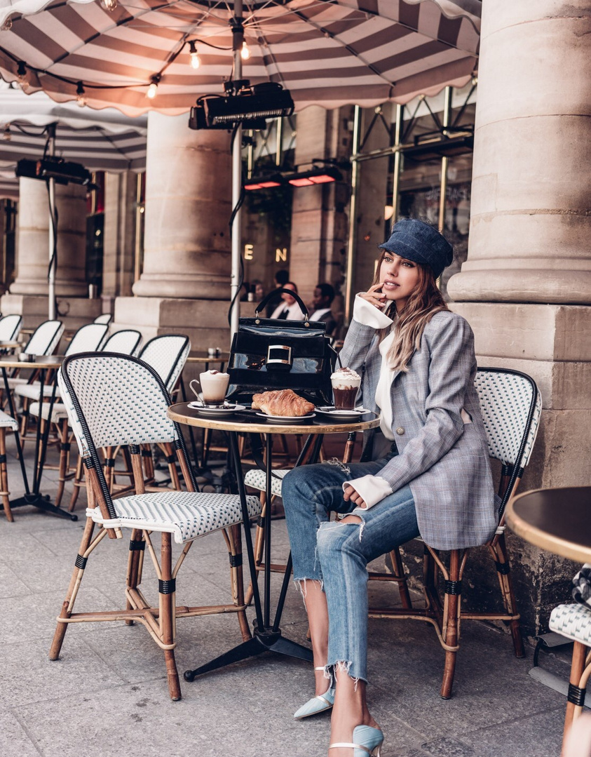 Sitting at a Paris Cafe and people watching - wearing a Tibi blazer, Dior Hat, and Malone Souliers mules
